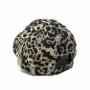 Close-up of distressed leopard print baseball cap with vintage worn details