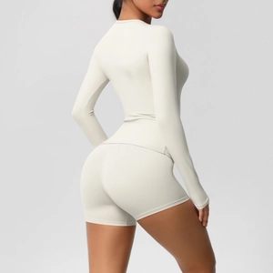 Detail of cream yoga set showing long sleeve top and high waist shorts from side view
