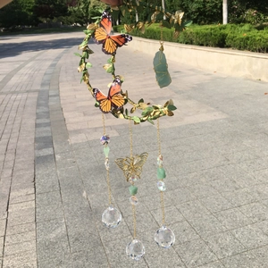 Handmade moon wind chime with green crystals, metal leaves, and clear crystal ball pendants