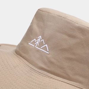 Detailed close-up of mountain embroidery and twill cotton fabric on khaki sun hat