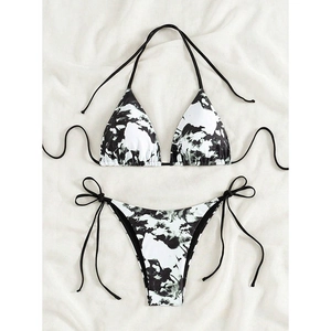 Close-up of black and white marble print bikini with tie-side detailing and halter neck