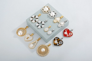 Close-up of elegant gold and silver pendants with pearls and rhinestones on blue blocks
