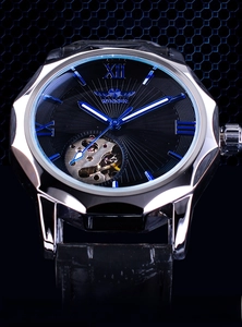 Detail of mechanical watch showing silver geometric case and skeleton dial with blue hands