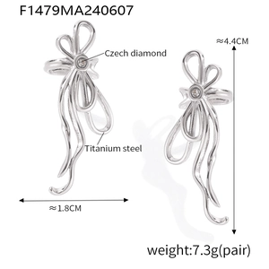 Macro detail of titanium steel U-shaped ribbon earrings with a sparkling Czech diamond