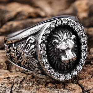 Macro shot of vintage lion head ring with sparkling white zircon border on wood