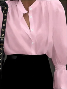 Detail of pink blouse showing white buttons, ruffled stand collar and lantern sleeves