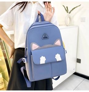 Close-up of cute blue cat-themed backpack with 3D ears and white paw details