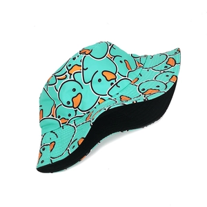 Detail of reversible teal bucket hat with cute cartoon yellow duck print and black lining