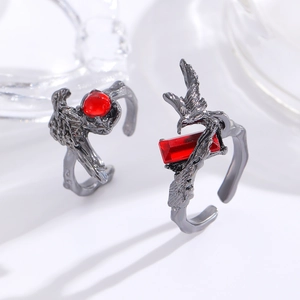 Detailed macro view of Gothic raven claw rings featuring deep red synthetic rubies
