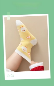 Close-up of yellow baby knee high sock with cartoon chick print and high elasticity