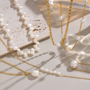 Golden stainless steel necklace featuring baroque and round natural freshwater pearls