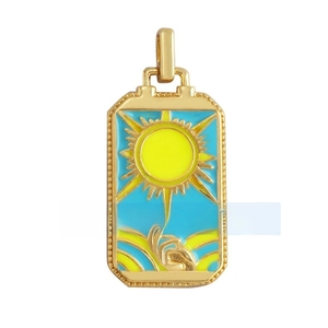 Macro detail of sun tarot card pendant in copper with zircon inlay and blue enamel