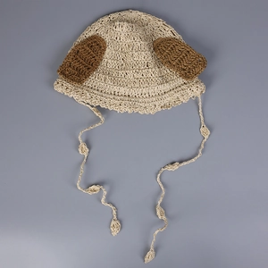 Detailed macro view of handmade crochet knit baby hat with cute brown dog ears and long ties