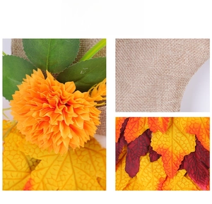 Detailed close-up of autumn wreath textures with fabric flowers, maple leaves, and burlap