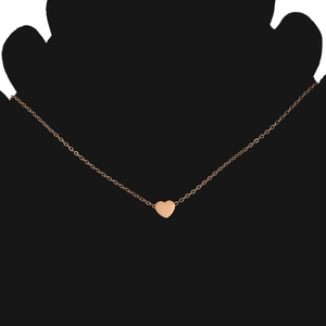 Close-up of a rose gold heart pendant necklace on a minimalist O-chain necklace