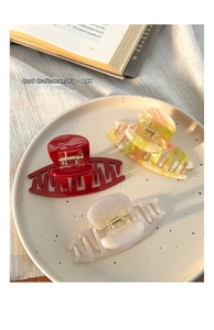 Three-piece set of large acrylic hair claws in red, marbled orange, and pearl white colors
