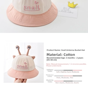 Detailed view of pink baby snail hat featuring soft cotton fabric and cute snail antennae