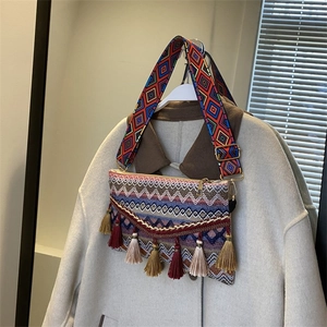 Detail of ethnic crossbody bag featuring colorful wave patterns and long tassels decor