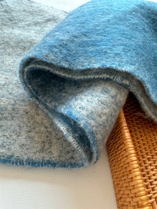 Close-up of blue-grey gradient scarf fabric showing soft cashmere-like wool texture