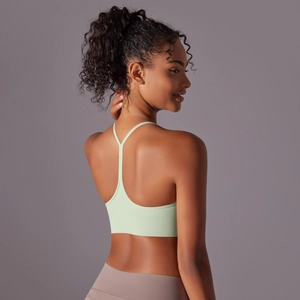 Close-up of mint green sports bra featuring thin Y-back straps and soft brushed fabric