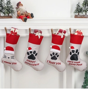 Set of four fabric pet Christmas stockings featuring cat and dog paw prints and cute phrases