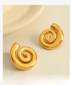 Détail de boucles d'oreilles spirales plaquées or 18 carats au design en métal torsadé