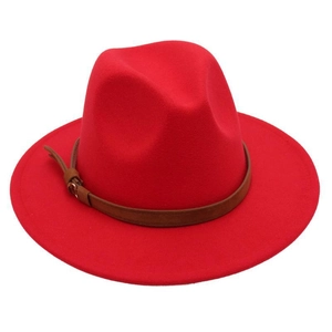 Detail of red fedora hat featuring a brown faux leather belt strap with metal buckle