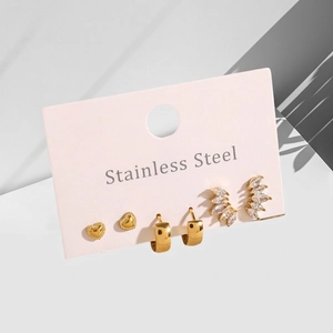 Three pairs of golden stainless steel earrings with heart, hoop, and zircon cluster designs