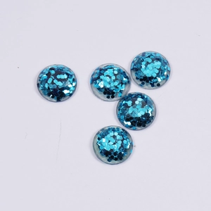 Detailed view of five blue round resin charms with sparkling glitter for DIY jewelry making