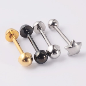 Detailed macro view of four stainless steel tongue rings in gold, black, and silver finishes
