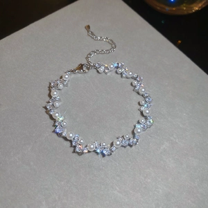 Close-up of pearl and zircon butterfly bracelet with shiny silver lobster clasp