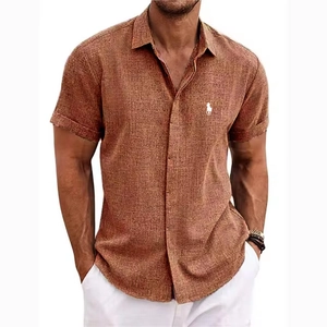 Close-up of brick red linen polo shirt featuring white embroidered horse logo detail