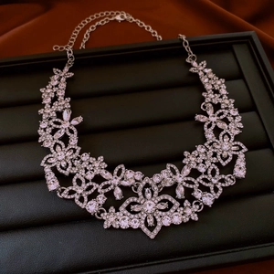 Detail of silver floral necklace with sparkling zircons on a black display tray