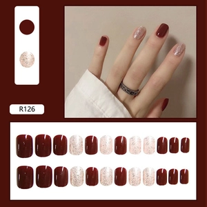 Detail view of R126 press-on nails in deep burgundy and silver glitter finishes