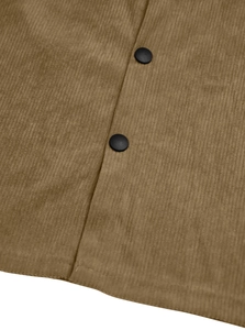 Macro shot of brown corduroy texture and black buttons on a men's workwear jacket