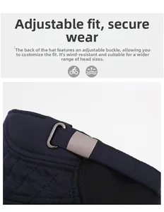 Detail of adjustable metal buckle and elastic strap on navy blue quilted winter hat
