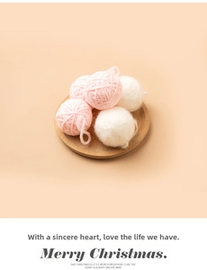 Pink and white knit yarn balls on wood tray for Christmas DIY decor and crafts
