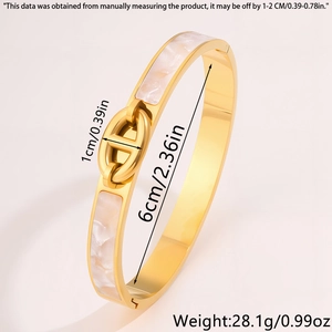 Detail view of 1cm wide golden stainless steel bangle with mother of pearl inlay