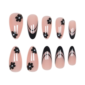 Pink almond press-on nails with black French tips and delicate floral patterns