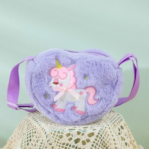 Detail of purple plush heart-shaped bag with unicorn embroidery and adjustable strap