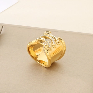 Detail of 18K gold-plated knotted ring with sparkling teardrop crystal inlay