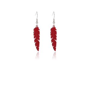 Detail of red feather drop earrings with silver hooks and elegant mirror reflection