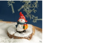 Detail view of resin Christmas snowman ornament measuring 7cm in height and 3.5cm in width