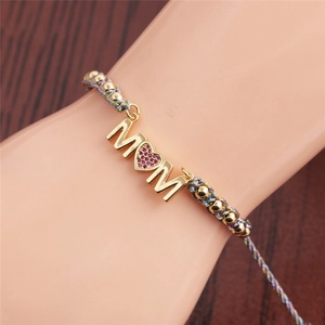 Adjustable golden MOM bracelet with colorful braided rope and heart-shaped red crystal