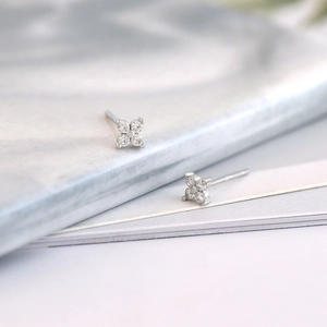 Macro detail of S925 silver flower stud earrings with sparkling clear cubic zirconia stones