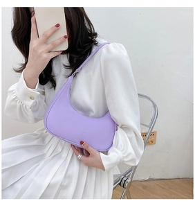 Detail of light purple nylon shoulder bag showing sleek texture and metal zipper