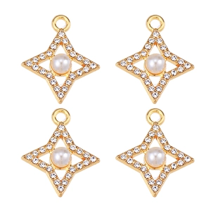 Macro shot of four gold star pendants with pearls and rhinestones on a white background