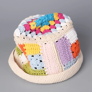 Detailed view of colorful crochet patchwork stitches and handmade texture on cotton bucket hat