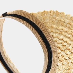 Detail of woven straw sun visor with striped elastic headband for breathable fit