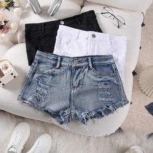 Three-color distressed denim shorts set with ripped details on a white sofa
